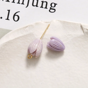 Detailed macro view of a light purple tulip charm for DIY jewelry with gold metal loop