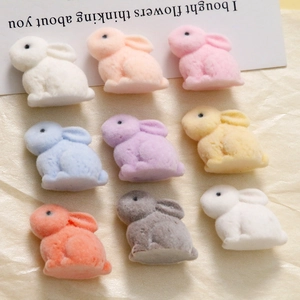 Macro view of colorful flocked bunny resin charms for DIY jewelry and hair accessories