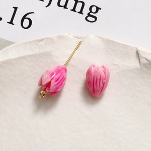 Macro shot of macaron pink tulip beads with detailed petal texture for DIY jewelry making