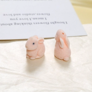 Close-up of pink flocked rabbit DIY resin charms with soft velvet texture for craft making