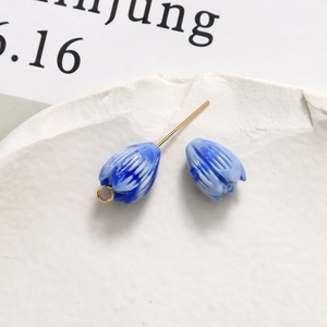 Macro view of blue gradient flower pendant with gold loop for DIY jewelry making