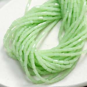 Detailed close-up of faceted light green glass beads for DIY jewelry and crafts