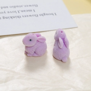 Detailed macro view of purple flocked rabbit resin charms for DIY jewelry making
