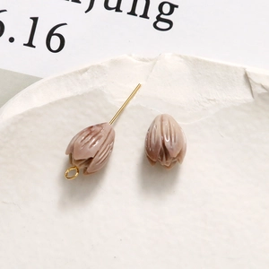 Detail of pink marble-textured resin flower charms for DIY jewelry crafting