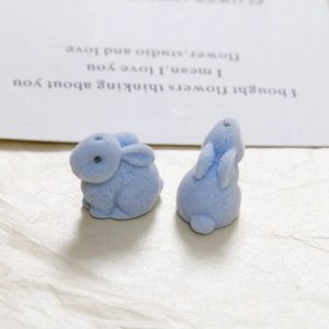 Close-up of a pair of light blue flocked cartoon rabbits for DIY craft and accessories