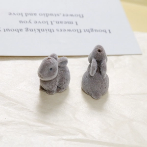 Macro shot of grey flocked rabbit resin accessories for DIY jewelry and hair crafts