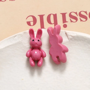 Detail of pink resin cartoon bunny charms for DIY jewelry and phone case making