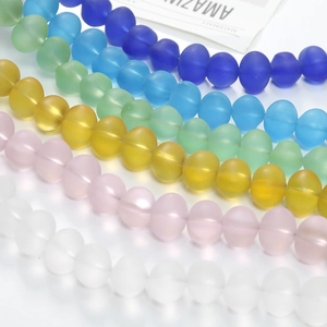 Close-up of colorful frosted translucent glass beads in various vibrant colors