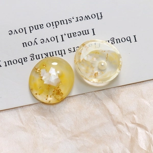 Macro-detail van hars cabochons met goudfolie en parels op een witte poëtische kaart