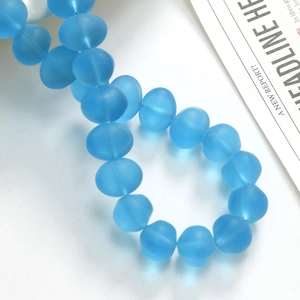Macro shot of matte blue translucent glass beads for DIY jewelry making and craft decor