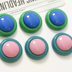 Close-up of vintage resin round color-blocked earrings and DIY jewelry accessories
