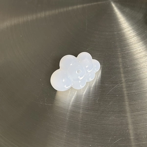 Macro detail of milky white translucent cloud-shaped acrylic jewelry pendant accessories