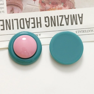 Macro view of round resin earring studs in vintage candy colors with a glossy finish