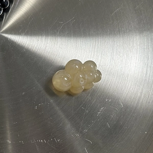 Close-up of semi-transparent yellow cloud bead with hole for DIY jewelry making
