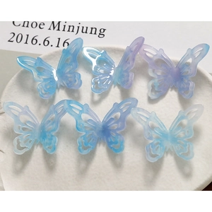 Detail of 6 gradient blue-purple hollow butterfly acetate charms with glitter finish