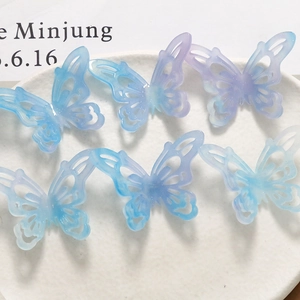 Detailed macro of six 3D hollow acetate butterflies with blue purple gradient and glitter