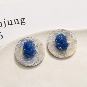 Detail of round acetate base with blue resin rose for DIY earring and hair jewelry