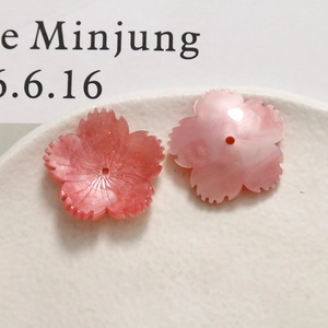 Macro shot of pink sakura cherry blossom acrylic beads for DIY jewelry making