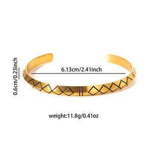 Detail showing 0.6cm width and 6.13cm inner diameter of gold Viking rune bangle