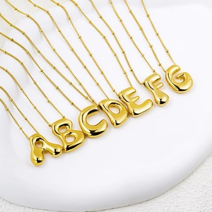 Detailed close-up of 3D bubble initial necklaces A-G in 18K gold plated titanium steel