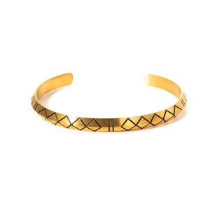 Detailed view of the 18k gold-plated cuff featuring black geometric Viking rune patterns