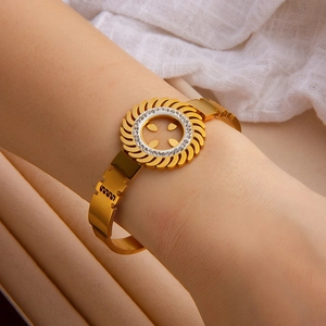 Close-up of golden sunflower bangle with sparkling diamonds and hollow pattern design