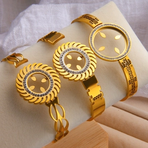 Three-piece set of golden stainless steel bracelets with sunburst and rhinestone designs