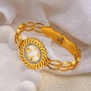 Detailed close-up of a golden hollowed sunburst bracelet with inlaid zircon crystals