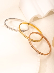 Detailed view of silver gold and rose gold clover bracelets with sparkling diamonds