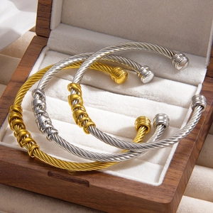 Three-piece set of twisted cable open bracelets in gold and silver stainless steel finishes