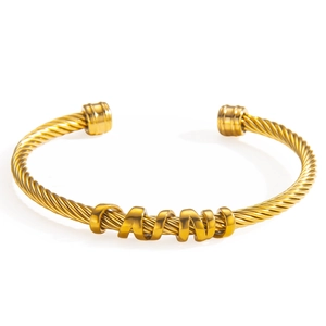 Gold twisted cable stainless steel open bangle featuring a polished MAMA letter charm