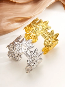 Detailed relief of 18k gold and silver plated rose floral patterns on a wide cuff bangle