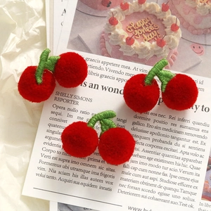 Three pieces of handmade plush red cherry charms with green stems for DIY crafts and accessories
