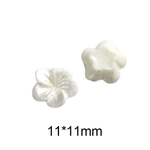 Close-up of 11mm pearl white 5-petal flower nail charms for DIY manicure art