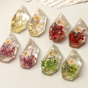 Handmade resin pendants with real dried flowers, gold foil, and pearl accents