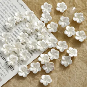 Detailed macro view of 11mm pearlescent white resin flower charms for nail art and DIY craft