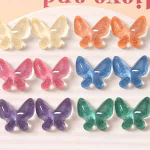 Close-up of colorful resin butterfly charms with cat-eye luster for DIY craft making