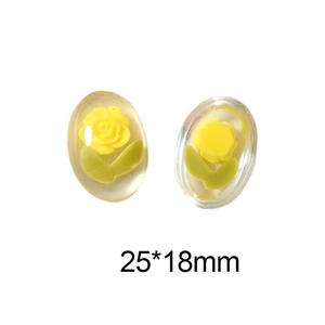 Macro shot of 25x18mm oval resin charms with yellow roses and green leaves for DIY crafts
