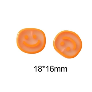 Macro detail of 18x16mm translucent orange resin smiling face charms for DIY jewelry