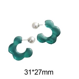 Detail of green resin flower earring with white pearl and black letter print