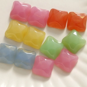 Close-up of assorted candy-colored resin cabochons with glossy finish for DIY crafts