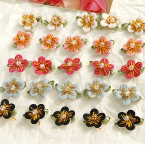 Handmade woven cotton flower charms with center beads for DIY jewelry and hair accessories