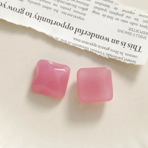 Detailed view of pink translucent resin square charms with a glossy smooth finish