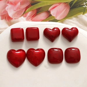 Macro view of deep red resin heart cabochons with marble texture for DIY jewelry