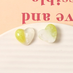 Macro detail of heart-shaped resin charms with green-white gradient marble texture