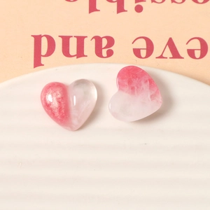 Macro shot of glittery pink and marble resin heart charms for DIY jewelry making