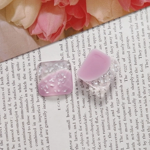 Detail of square pink and white resin charms with shell glitter for DIY jewelry making