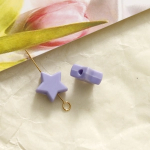 Detail view of a 10mm lavender star bead with center hole on a gold pin for DIY jewelry