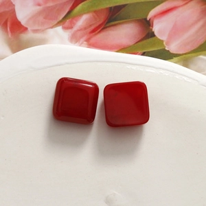 Detail of glossy red resin heart cabochons for DIY jewelry and hair accessories
