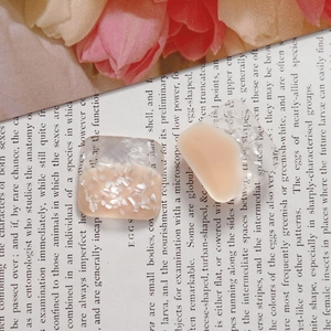 Detail of square resin charms with natural shell inlay and glossy cream finish